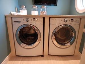 a high end washer and dryer set up in a dedicated laundry room