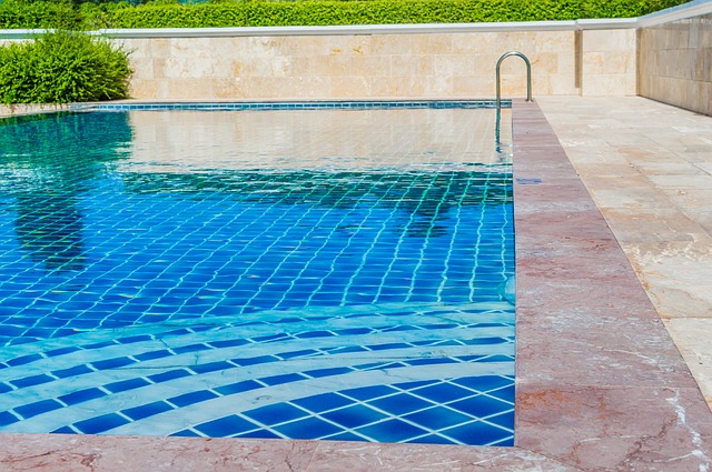 swimming pool behind luxury home