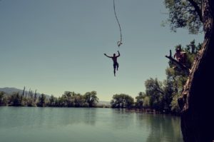 Man jumping into lake.