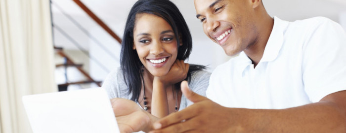 couple looking at laptop happily